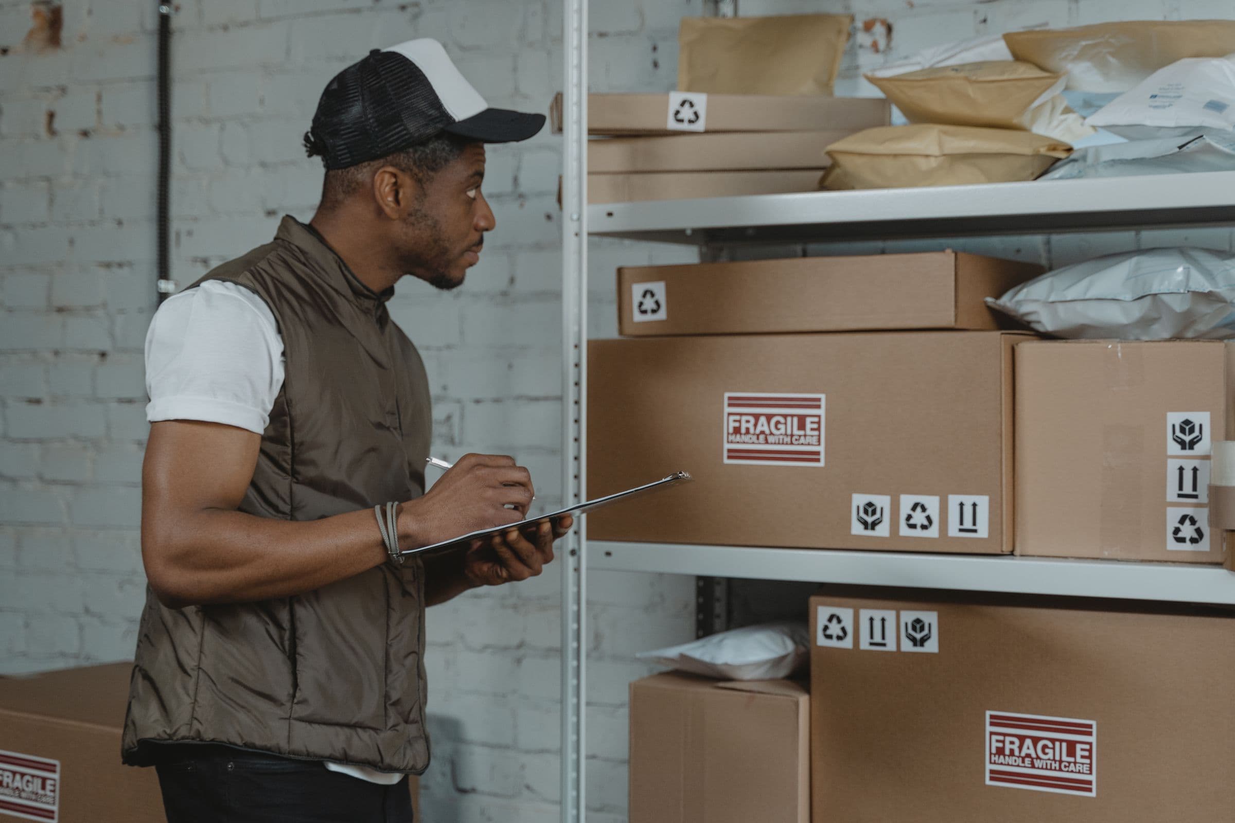 A warehouse worker checks parcels and labels during order picking
