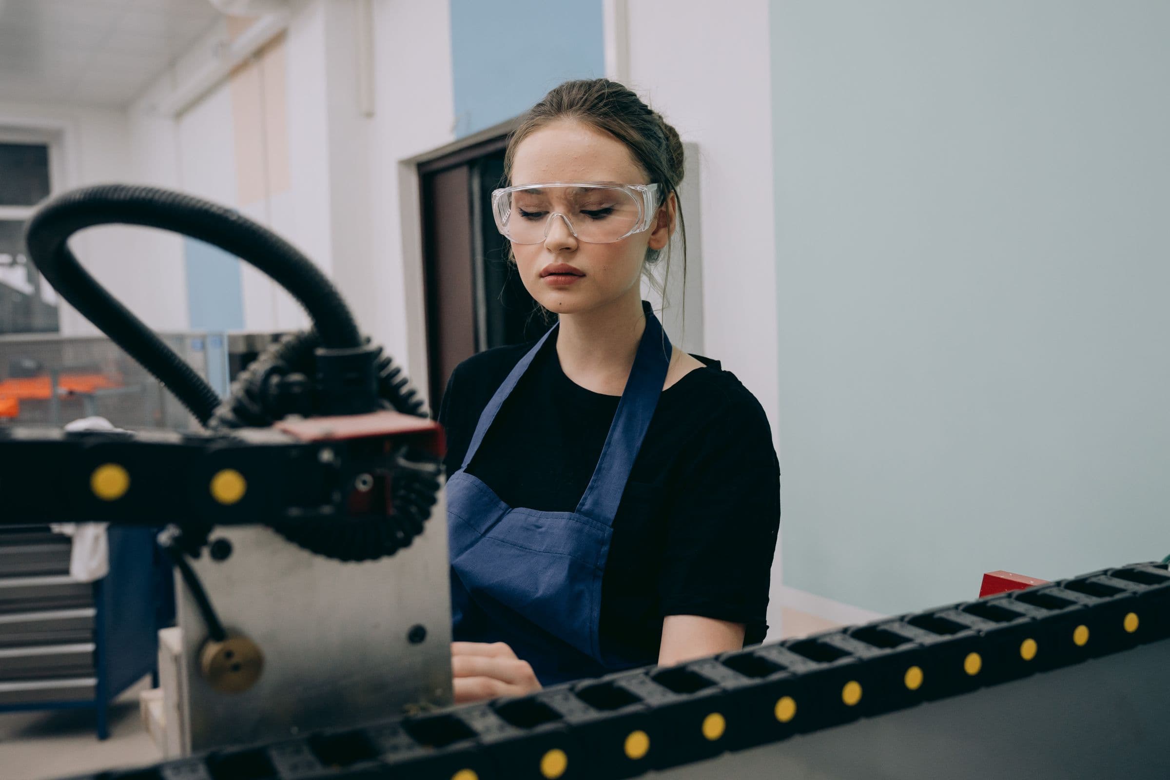 An operator runs a machine on a production line